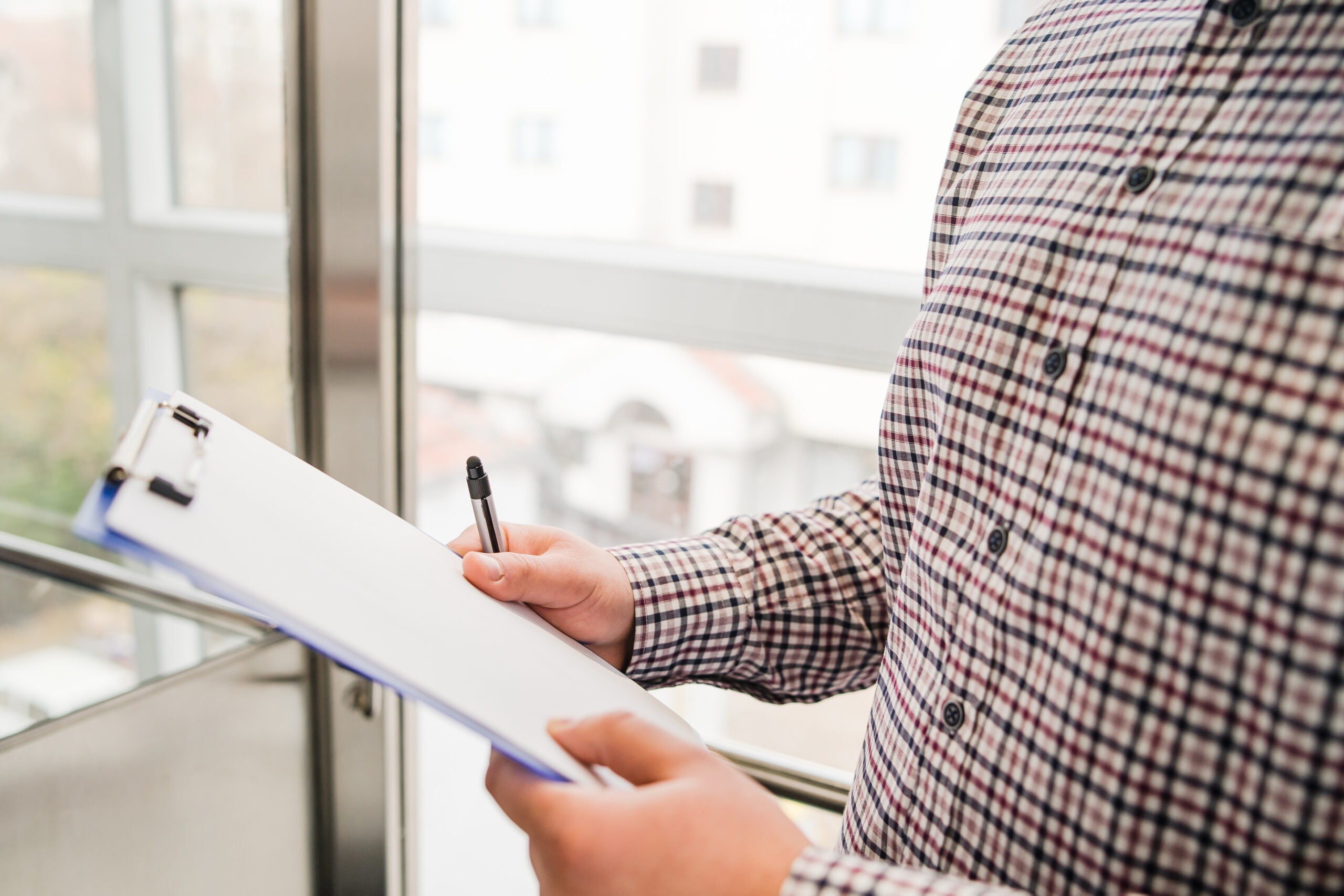 midsection-man-holding-paper-office